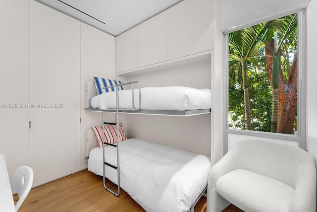 11 La Gorce Cir, Miami Beach, FL 33141 - bedroom featuring multiple windows and light wood-style floors