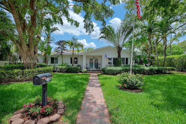 7340 SW 123rd Ter, Pinecrest, FL 33156 - view of front facade featuring french doors, a front yard, and stucco siding