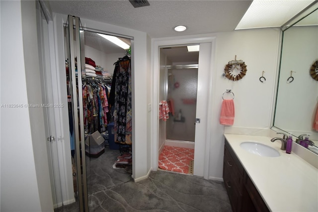100 SW 130th Unit 311C, Pembroke Pines, FL 33027 - full bathroom with vanity, a spacious closet, a shower stall, and a textured ceiling