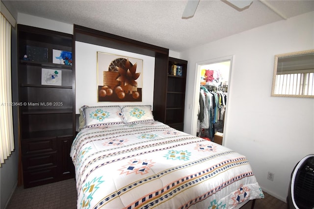 100 SW 130th Unit 311C, Pembroke Pines, FL 33027 - carpeted bedroom with a spacious closet, a closet, a textured ceiling, and a ceiling fan