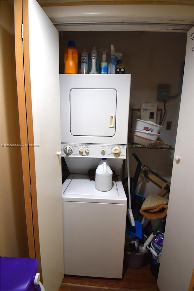 100 SW 130th Unit 311C, Pembroke Pines, FL 33027 - laundry area with stacked washer and clothes dryer and wood finished floors