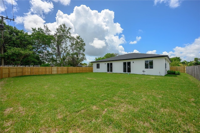 10741 SW 217th St, Miami, FL 33170 - rear view of house featuring a fenced backyard and stucco siding