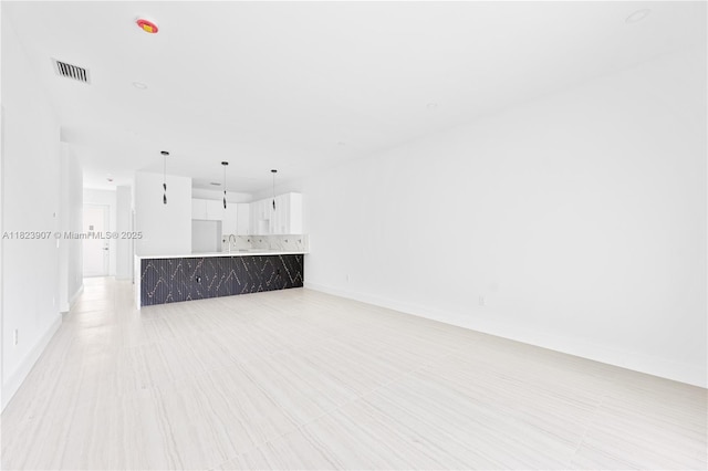 10741 SW 217th St, Miami, FL 33170 - unfurnished living room with a sink and baseboards