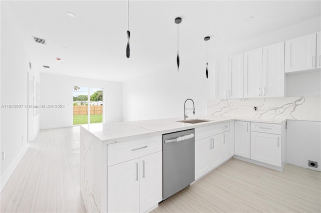 10741 SW 217th St, Miami, FL 33170 - kitchen with dishwasher, a peninsula, light stone countertops, white cabinetry, and backsplash