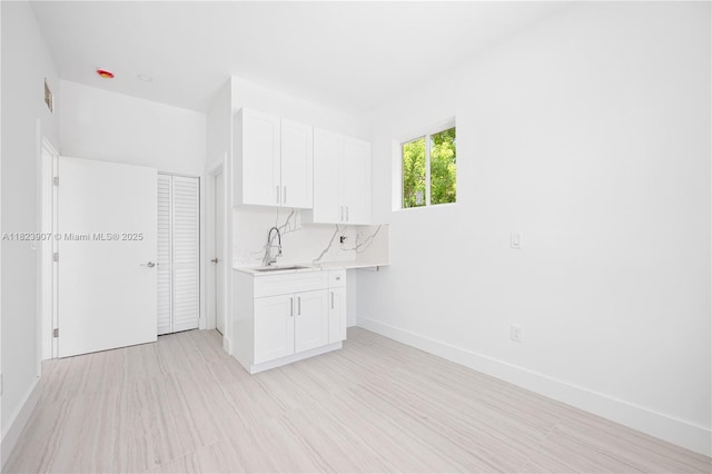 10741 SW 217th St, Miami, FL 33170 - kitchen featuring light countertops, white cabinetry, and light wood-style floors