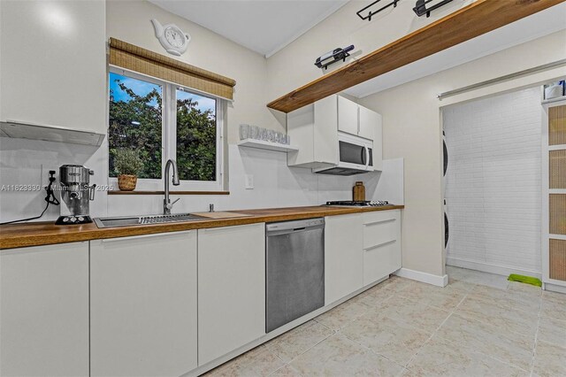 10371 SW 146th St, Miami, FL 33176 - kitchen featuring stainless steel dishwasher, open shelves, wooden counters, white cabinetry, and white microwave