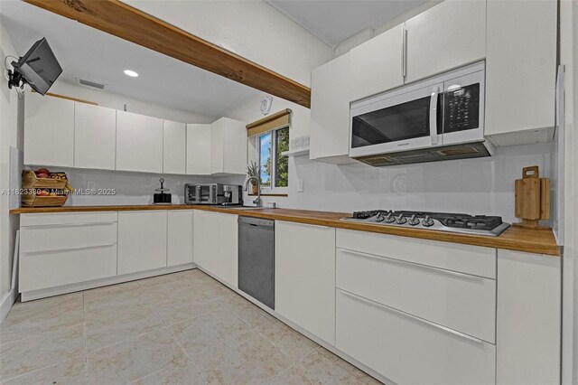 10371 SW 146th St, Miami, FL 33176 - kitchen featuring white microwave, dishwashing machine, stainless steel gas stovetop, white cabinetry, and light tile patterned floors