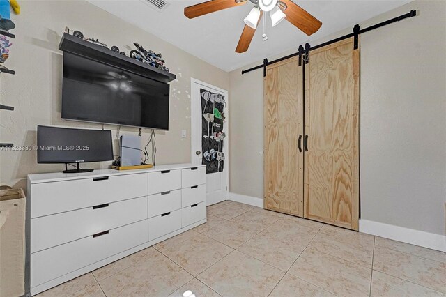 10371 SW 146th St, Miami, FL 33176 - bedroom featuring a barn door and light tile patterned flooring