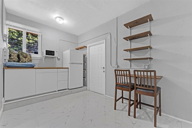 10371 SW 146th St, Miami, FL 33176 - dining area with light marble finish floors and a textured ceiling