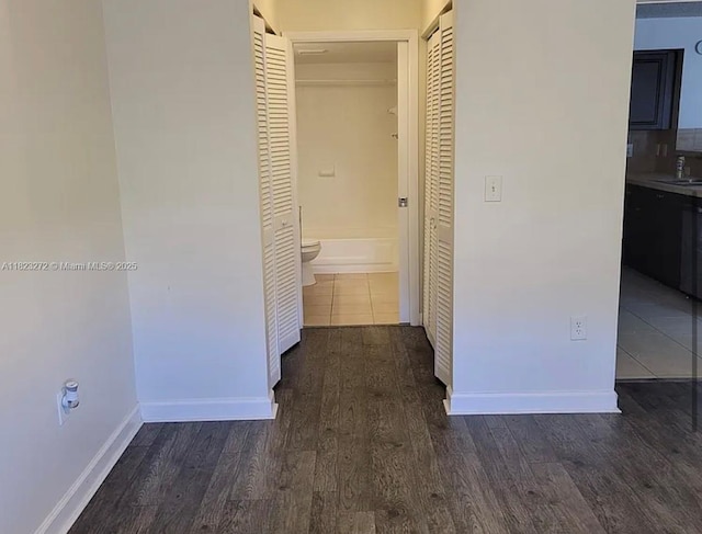 1733 Village Blvd Unit 105, West Palm Beach, FL 33409 - hall featuring dark wood finished floors and baseboards