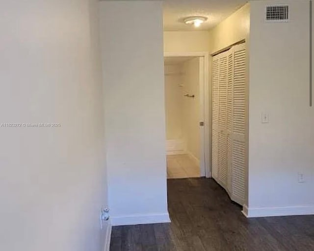 1733 Village Blvd Unit 105, West Palm Beach, FL 33409 - hall featuring baseboards and dark wood-type flooring