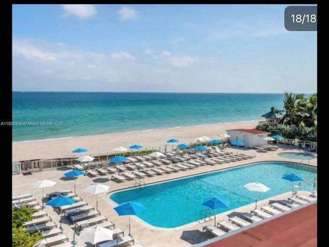 19201 Collins Ave, Sunny Isles Beach, FL 33160 - community pool featuring a hot tub, view of water and beach, and a patio area