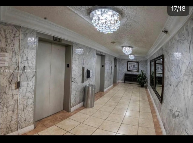 19201 Collins Ave, Sunny Isles Beach, FL 33160 - hall featuring elevator, a textured ceiling, ornamental molding, a chandelier, and light tile patterned floors
