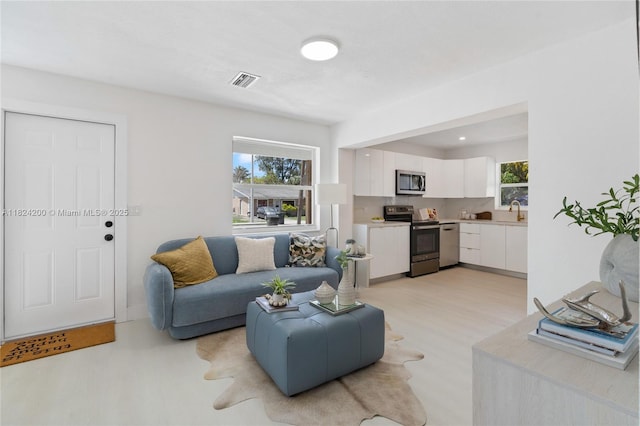 813SW 3rd Ct, Delray Beach, FL 33444 - living area featuring plenty of natural light and light wood-style floors