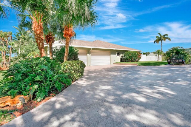 20406 SW 54th Pl, Pembroke Pines, FL 33332 - view of front facade featuring a garage, driveway, and stucco siding