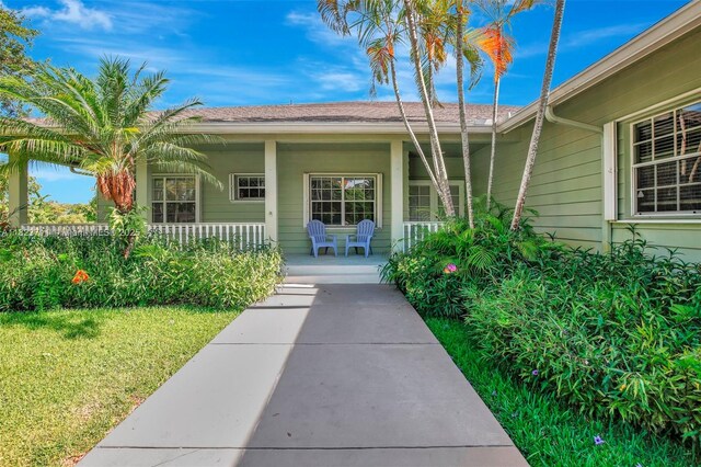 20406 SW 54th Pl, Pembroke Pines, FL 33332 - view of exterior entry with covered porch and a yard