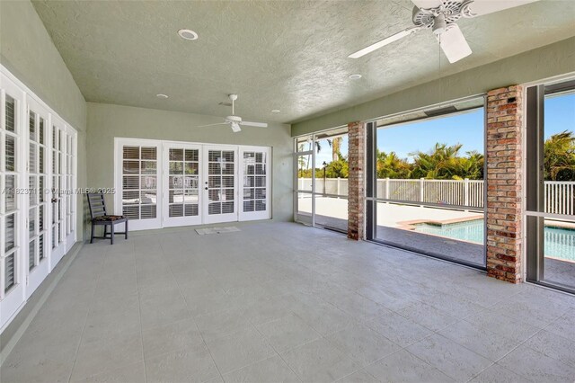 20406 SW 54th Pl, Pembroke Pines, FL 33332 - unfurnished sunroom featuring a ceiling fan, french doors, and healthy amount of natural light