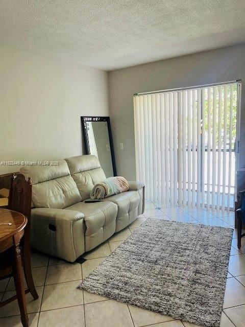 8701 SW 12th St Unit 30, Miami, FL 33174 - living room featuring light tile patterned floors and a textured ceiling