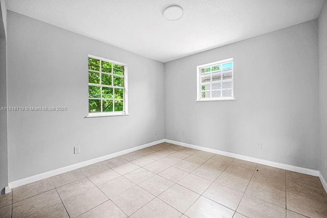 14180 NW 22nd Ave Unit 4, Opa-Locka, FL 33054 - spare room featuring plenty of natural light and light tile patterned flooring