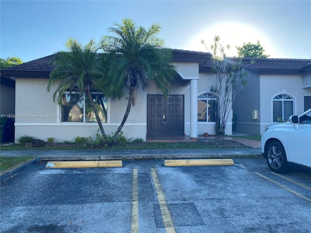 18942 NW 86th Ct, Hialeah, FL 33015 - view of front of home with uncovered parking and stucco siding