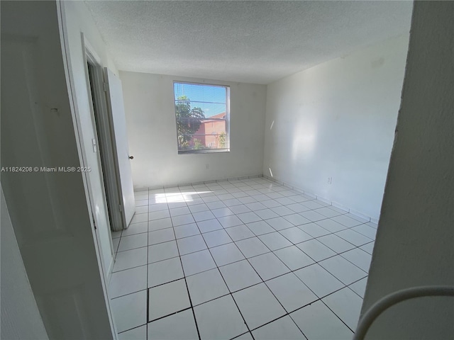 18942 NW 86th Ct, Hialeah, FL 33015 - unfurnished room featuring a textured ceiling and light tile patterned flooring