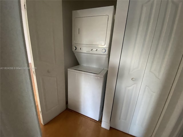 18942 NW 86th Ct, Hialeah, FL 33015 - laundry area with stacked washer / drying machine and wood finished floors