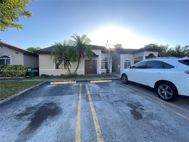 18942 NW 86th Ct, Hialeah, FL 33015 - view of front facade with uncovered parking and stucco siding