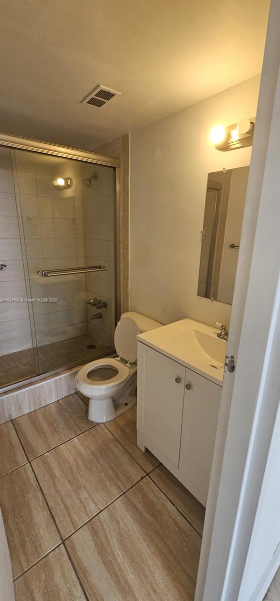 3660 NE 166th St Unit 503, North Miami Beach, FL 33160 - full bathroom featuring vanity, tile patterned flooring, and a stall shower