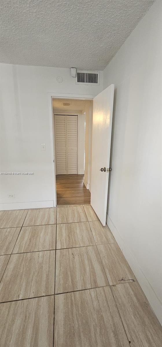 3660 NE 166th St Unit 503, North Miami Beach, FL 33160 - unfurnished room with a textured ceiling and wood finished floors