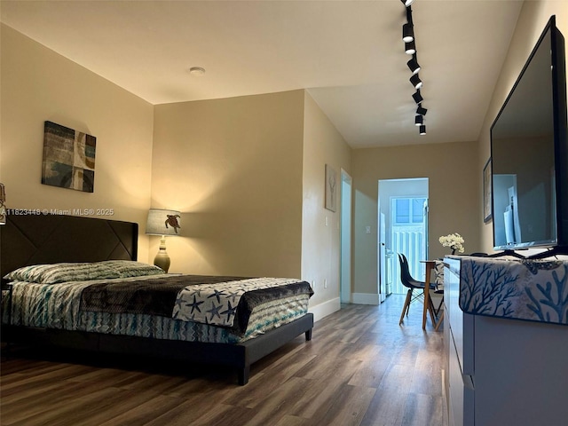 8132 Harding Ave Unit 2, Miami Beach, FL 33141 - bedroom featuring rail lighting and wood finished floors