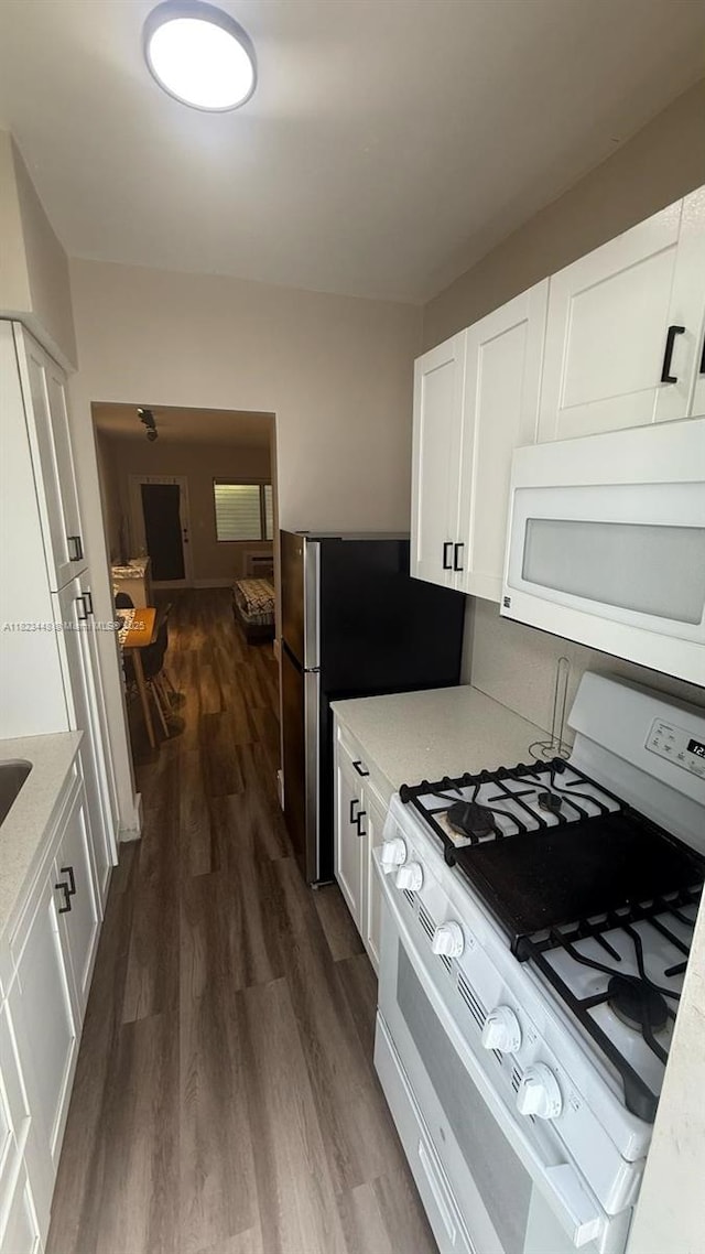 8132 Harding Ave Unit 2, Miami Beach, FL 33141 - kitchen with white appliances, dark wood-type flooring, white cabinets, and light stone countertops