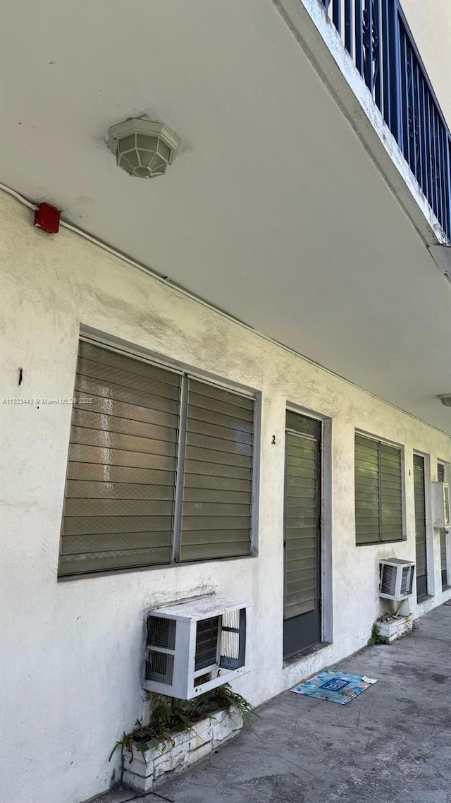 8132 Harding Ave Unit 2, Miami Beach, FL 33141 - entrance to property featuring stucco siding and a wall mounted AC