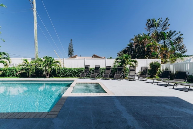 203 SE 8th St, Dania Beach, FL 33004 - view of swimming pool with a patio, a fenced backyard, and a pool with connected hot tub