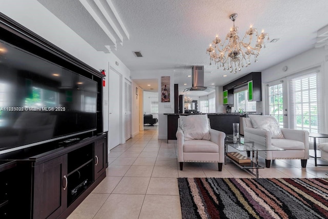 203 SE 8th St, Dania Beach, FL 33004 - living area featuring a textured ceiling, a chandelier, and light tile patterned floors