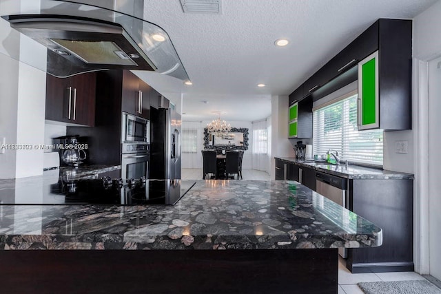 203 SE 8th St, Dania Beach, FL 33004 - kitchen with stainless steel appliances, exhaust hood, a chandelier, dark stone counters, and recessed lighting