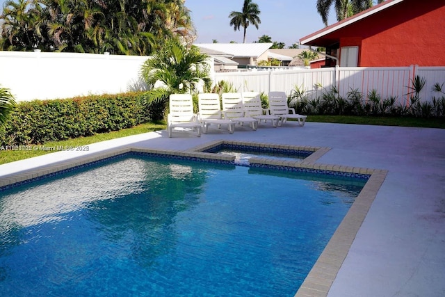 203 SE 8th St, Dania Beach, FL 33004 - view of pool featuring a patio, a fenced backyard, and a pool with connected hot tub
