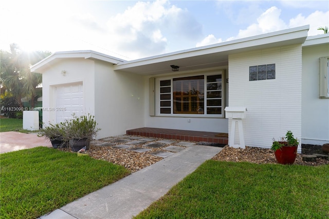9351 SW 53rd St, Miami, FL 33165 - view of front of house featuring a garage, stucco siding, and a front lawn