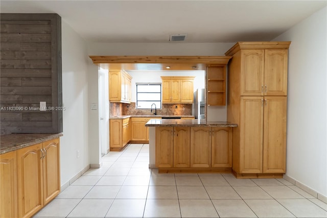 9351 SW 53rd St, Miami, FL 33165 - kitchen with stainless steel refrigerator with ice dispenser, a peninsula, decorative backsplash, dark stone countertops, and light tile patterned floors