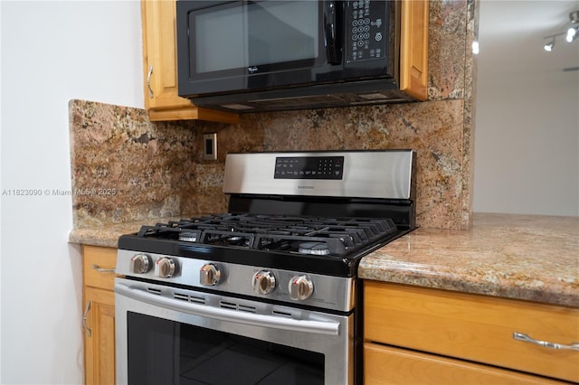 9351 SW 53rd St, Miami, FL 33165 - kitchen featuring stainless steel gas stove, black microwave, and tasteful backsplash