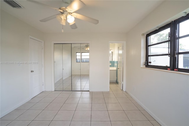 9351 SW 53rd St, Miami, FL 33165 - unfurnished bedroom featuring light tile patterned floors, a closet, a ceiling fan, and connected bathroom