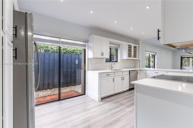 272 Fairway Cir Unit 98, Weston, FL 33326 - kitchen featuring appliances with stainless steel finishes, white cabinets, tasteful backsplash, light wood-type flooring, and recessed lighting