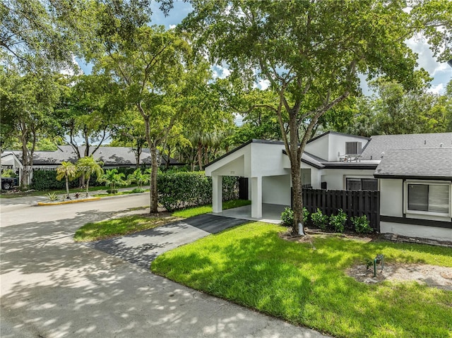 272 Fairway Cir Unit 98, Weston, FL 33326 - view of front facade featuring stucco siding, roof with shingles, asphalt driveway, and a carport