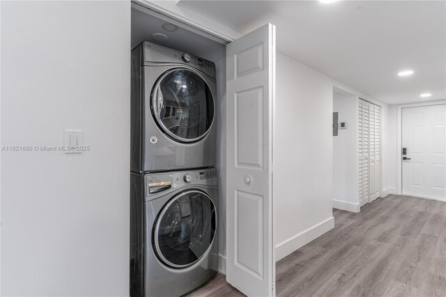 272 Fairway Cir Unit 98, Weston, FL 33326 - washroom with stacked washing machine and dryer, light wood finished floors, and recessed lighting