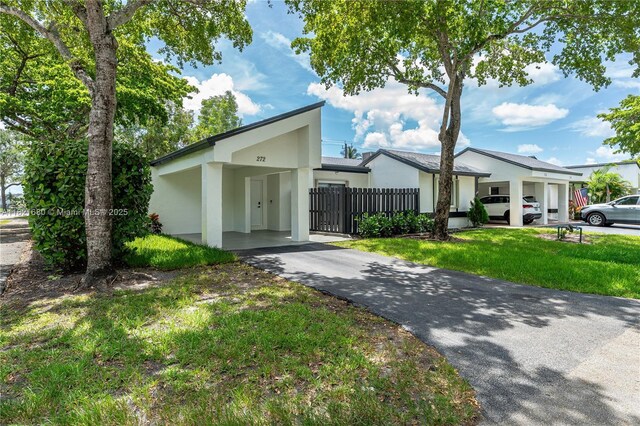 272 Fairway Cir Unit 98, Weston, FL 33326 - mid-century home with stucco siding, driveway, and an attached carport