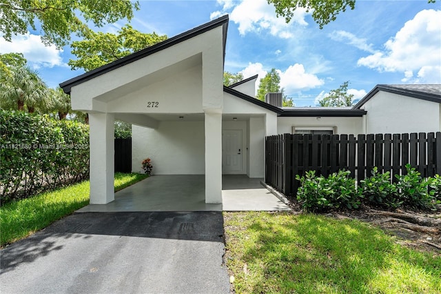272 Fairway Cir Unit 98, Weston, FL 33326 - view of front of property with stucco siding, asphalt driveway, and an attached carport