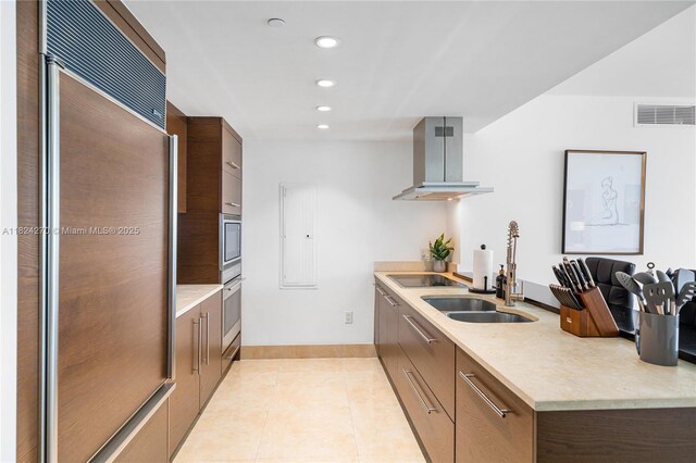495 Brickell Unit 5705, Miami, FL 33131 - kitchen with paneled refrigerator, wall chimney exhaust hood, modern cabinets, black electric cooktop, and light tile patterned floors