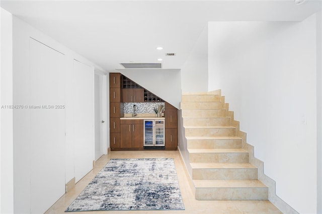 495 Brickell Unit 5705, Miami, FL 33131 - indoor bar with wine cooler, backsplash, stairs, recessed lighting, and light tile patterned floors