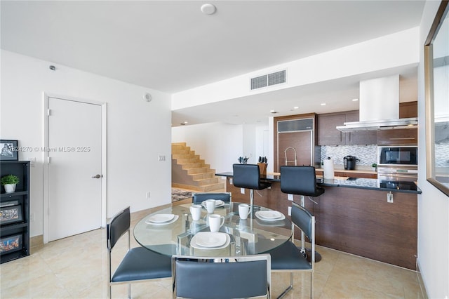 495 Brickell Unit 5705, Miami, FL 33131 - dining room featuring stairway, light tile patterned floors, and recessed lighting