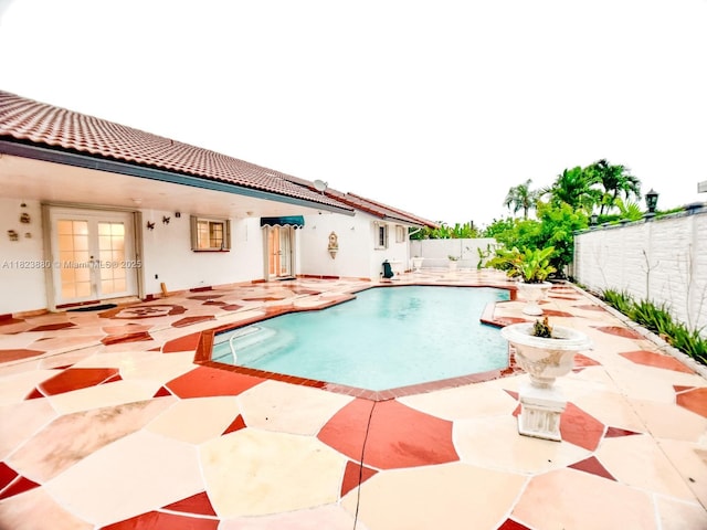 14332 SW 38th Ter, Miami, FL 33175 - view of swimming pool with french doors, a patio, and a fenced backyard