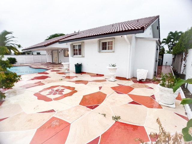 14332 SW 38th Ter, Miami, FL 33175 - back of property featuring a patio area, a fenced backyard, a tile roof, and stucco siding